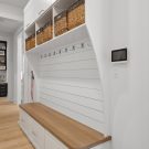 Custom entry way mudroom with hooks and bench with drawers for storage