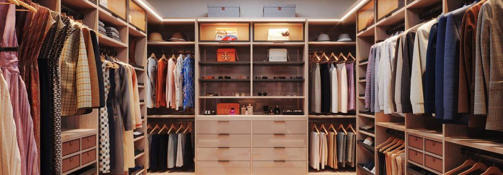 Luxury walk-in closet with warm wood tones and integrated lighting, showcasing custom shelving, hanging space, drawers, and display areas