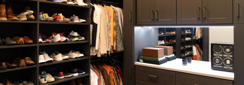 Custom mans closet with dark woodgrain and display shoe shelf