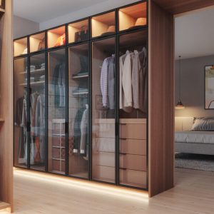 Luxury walk-in custom closet contemporary glass-front wardrobe system in Rocky Mountain melamine with LED toe-kick lighting, double-hang rods, and stacked drawer towers. Overhead display cubbies highlight accessories and seasonal storage.