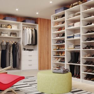 Custom closet system in Almond melamine with full-height shoe shelving, double-hang wardrobe rods, and integrated drawer towers.