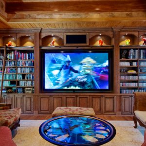 Custom entertainment and media center with book shelves for movies and LED lighting