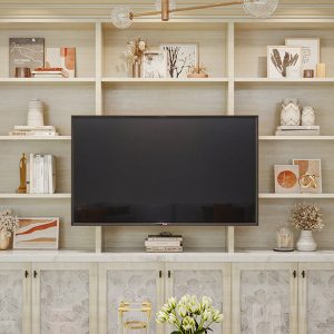 Built-in shelving around TV with decorative cabinet door fronts