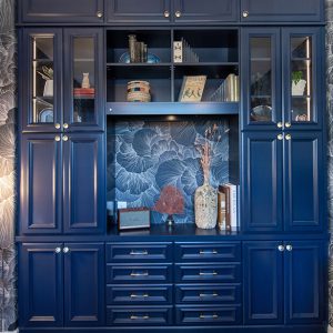 Floor-to-ceiling built-in blue cabinetry in home library