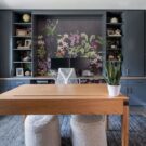 A custom wall unit credenza in a sophisticated blue-grey finish, featuring an integrated computer workstation, hidden cabinet storage, and open display shelving.