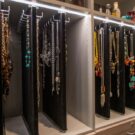 Custom jewelry organization at its finest: hidden pull-out, double-sided velvet panels concealed behind decorative wire-mesh cabinet doors.