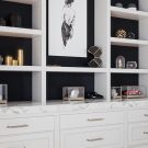 Custom shelving and display built-in with matte black accents and marble counter