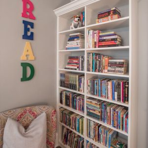Kids reading corner with custom built in shelving and crown molding