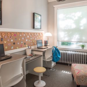 Kids media room with cork board wall and built-in desks