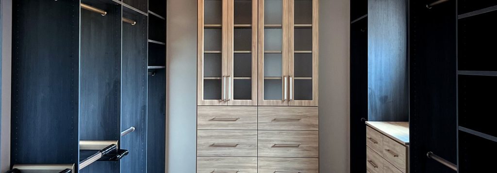 Custom wall unit and walk-in closet shelving with double hanging rods by Closet Factory Knoxville