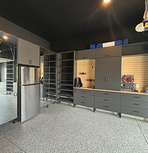 Garage storage cabinets in slate grey with slatwall organizer and built in fridge
