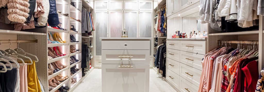 Custom walk in closet with center island with jewelry pullouts