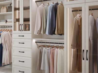 Reach-in closet with elegant white wood cabinetry, LED lighting, and pull-out shoe storage and double hanging garment rods.