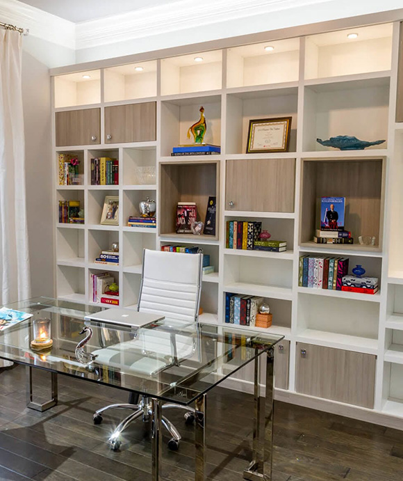 Built in wall shelving system with LED lighting and dual done cabinetry