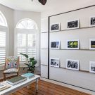 Hidden wall bed behind gallery wall