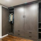 Custom wall bed in concealed dark melamine cabinetry