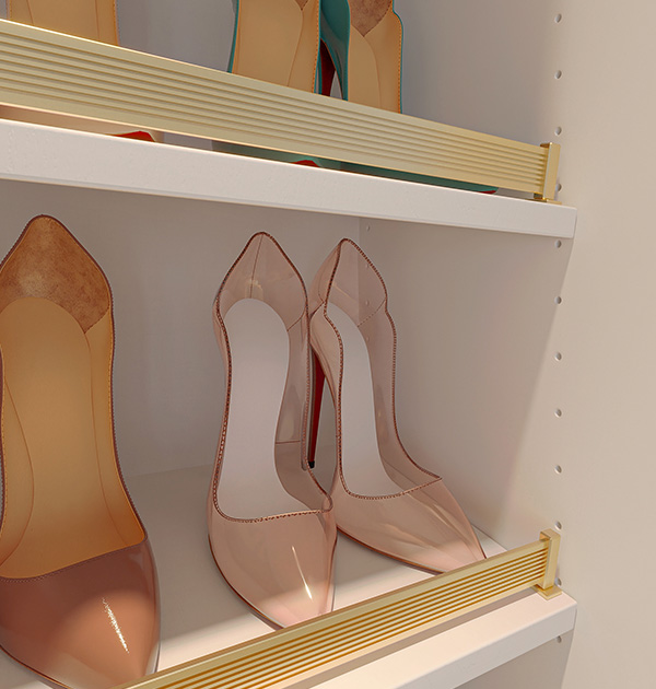 Custom closet shoe shelves with gold-tone shoe fences neatly displaying designer heels.