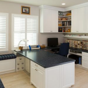 Craft room Thread storage wall, ribbon rods, and media shelving built into White Chocolate Raised Panel cabinetry