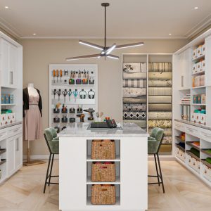 Craft room Shaker cabinets with craft room accessories including ribbon dispensers, fabric pull-outs, and a tool wall. Center island features open basket storage.