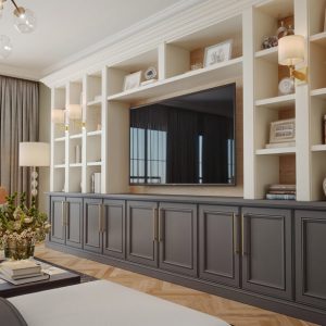 Custom built-in entertainment center with dark brown media cabinets for hidden storage and display shelving
