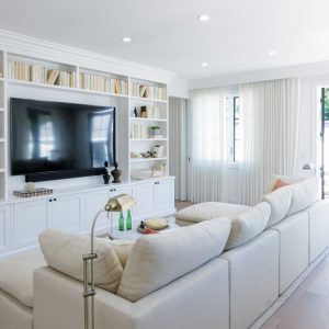 Living room with built in white shaker cabinets and book shelves