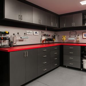 Custom garage cabinetry with slatwall organizers, fishing racks, and utility hooks