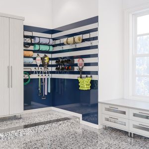 Garage setup with mounted sports gear organizers, cabinetry with lighting, and a wraparound bench