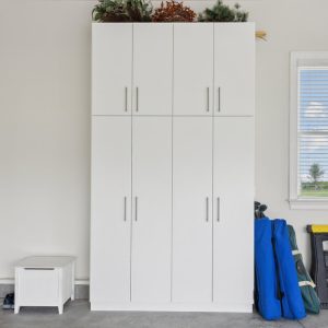 Garage with white cabinetry with integrated handles, slatwall system for garden tools and power equipment