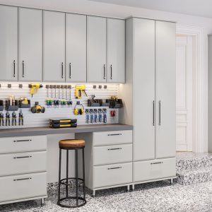 Garage system with flat-panel cabinets in Dove Grey, featuring a built-in workbench, utility hooks, tool organizers, and a full-width metal Slatwall system.