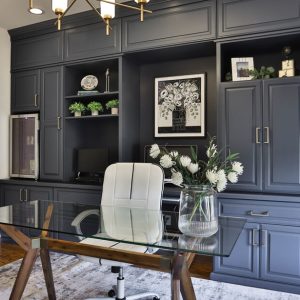 Custom home office grey cabinetry with wall safe and mini fridge