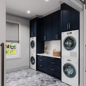 Laundry room with dual washer and dryer with folding station and dark blue upper cabinetry