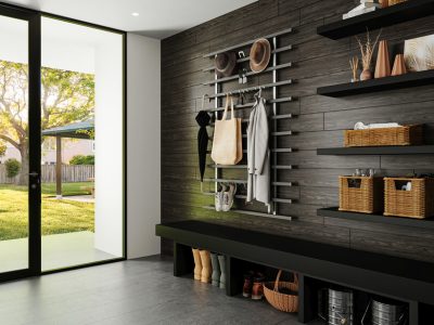 Modern mudroom with a black bench, black wood-paneled wall, and minimalist metal peg system for coats and hats
