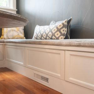 L-shaped breakfast nook with white bench seating and under-bench drawer storage
