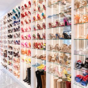Boutique-style shoe closet with glass shelves