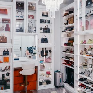 Shoe closet with built-in vanity and glass door fronts