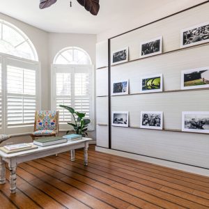 Wall bed disguised as a photo gallery installation