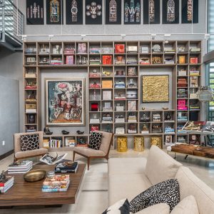 Modern wall-to-wall shelving with grid layout and integrated art display