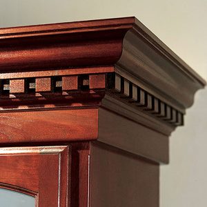 Dentil crown molding shown in cherrywood custom stained