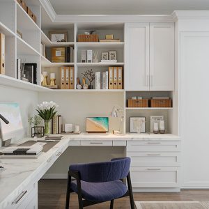 Home office with concealed built-in wall bed, wraparound desk, and open shelving.