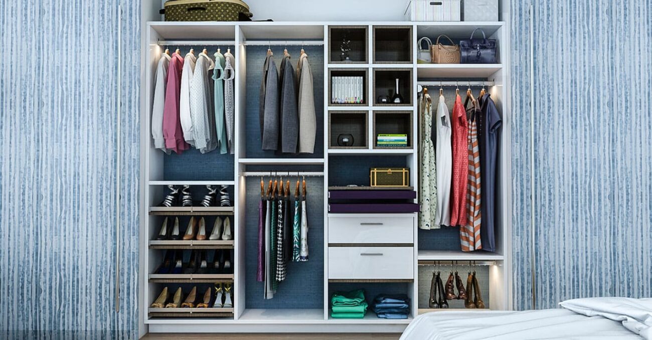 Reach-in closet featuring open shoe shelving with elite toe tops, LED lit hanging rods, and upper storage for luggage.