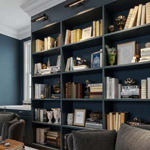 Built-in bookcases with library lighting and crown molding.