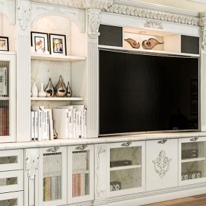 Traditional white entertainment center with ornate crown molding, fluted pilasters, built-in shelving, and glass cabinet doors.