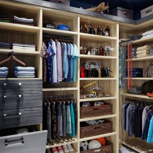 Children's clothing in reach-in closet featuring pull-out tie rack, dual level hanging rods, upper storage, and woven baskets.