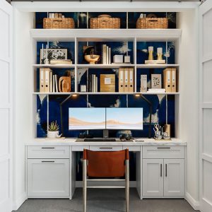 Built-in work station into closet with open shelving and integrated LED lighting.