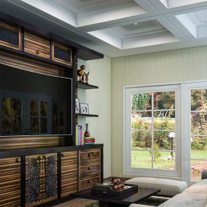 Modern custom entertainment center with floating shelves, textured paneling, and a central TV display.