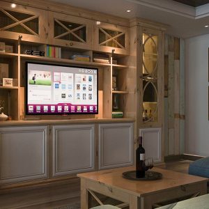 Entertainment center featuring integrated TV nook, display shelving with overhead lighting, and lower concealed cabinets for storage