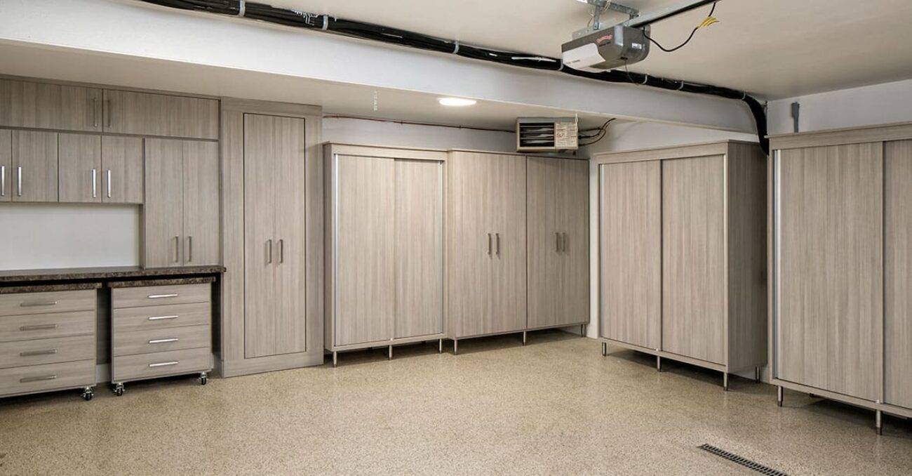 Garage cabinetry with sliding doors and workstation drawers on wheels for easy mobility.