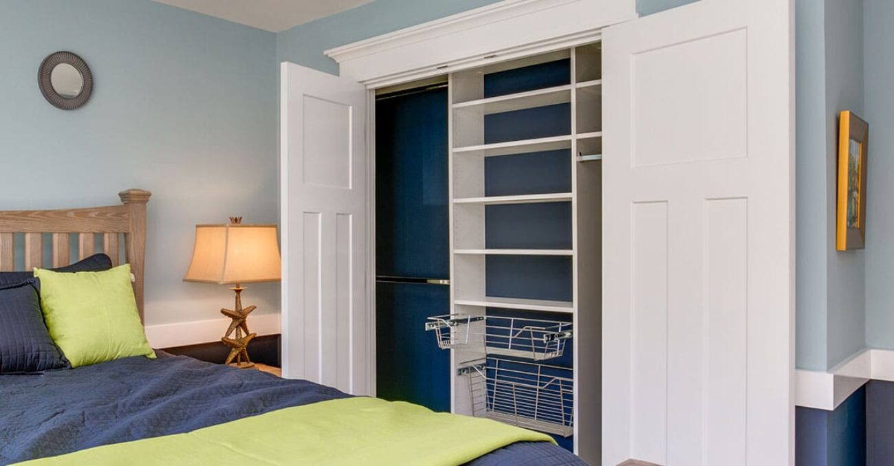 Reach-in closet with pull out wire baskets and dual hanging rods.